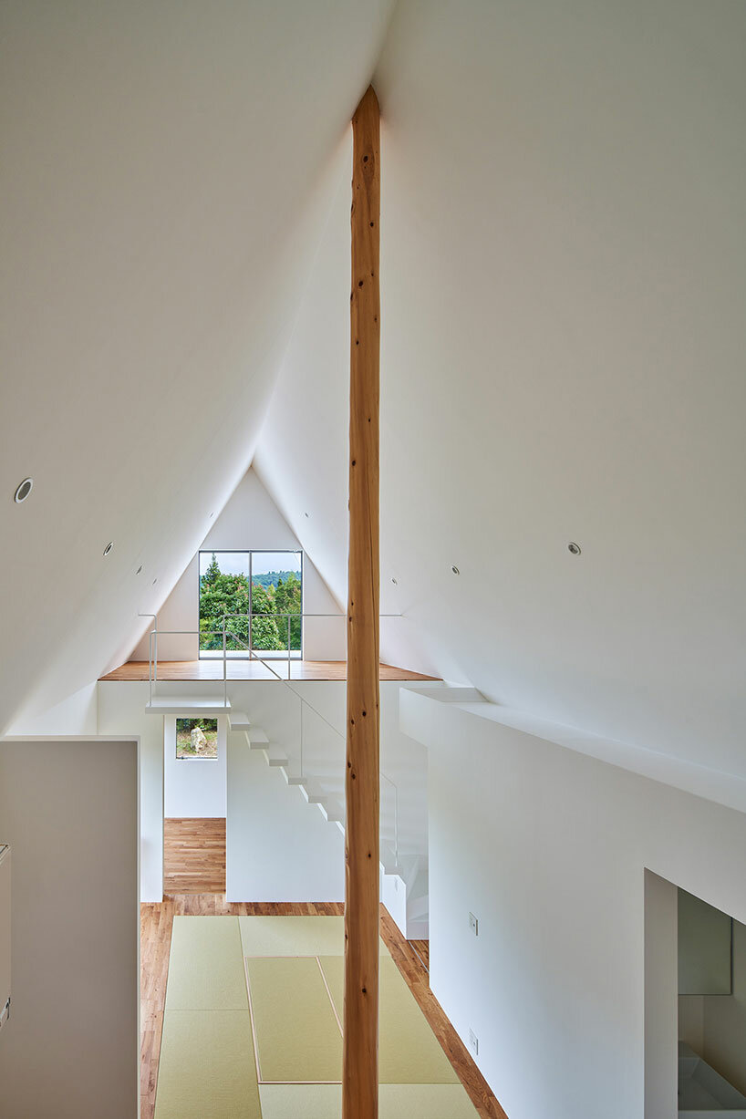 cut-out triangular roof frames extensive panoramas of rural japan