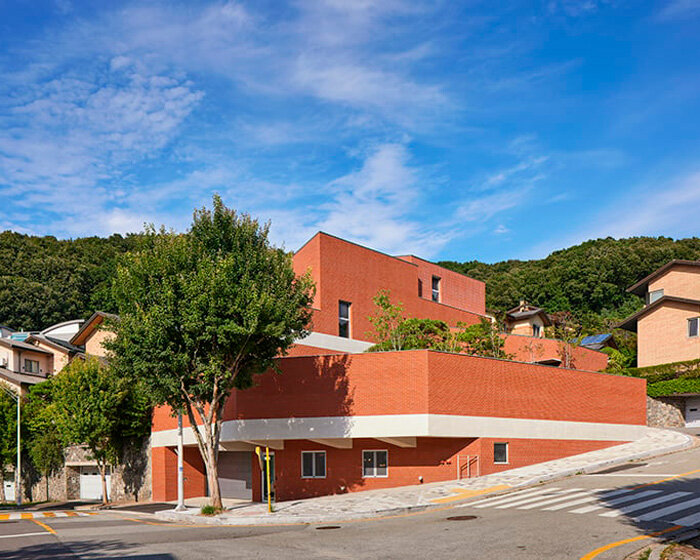 red brick residence in seongnam stacks fragmented three-story volume
