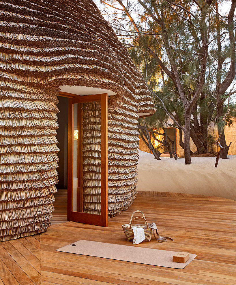 'kisawa' resort weaves undulating thatched-roof villas into the sand dunes of mozambique