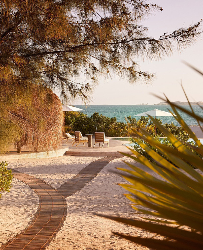 'kisawa' resort weaves undulating thatched-roof villas into the sand dunes of mozambique