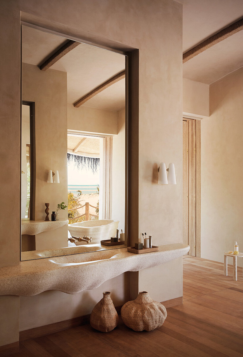 'kisawa' resort weaves undulating thatched-roof villas into the sand dunes of mozambique