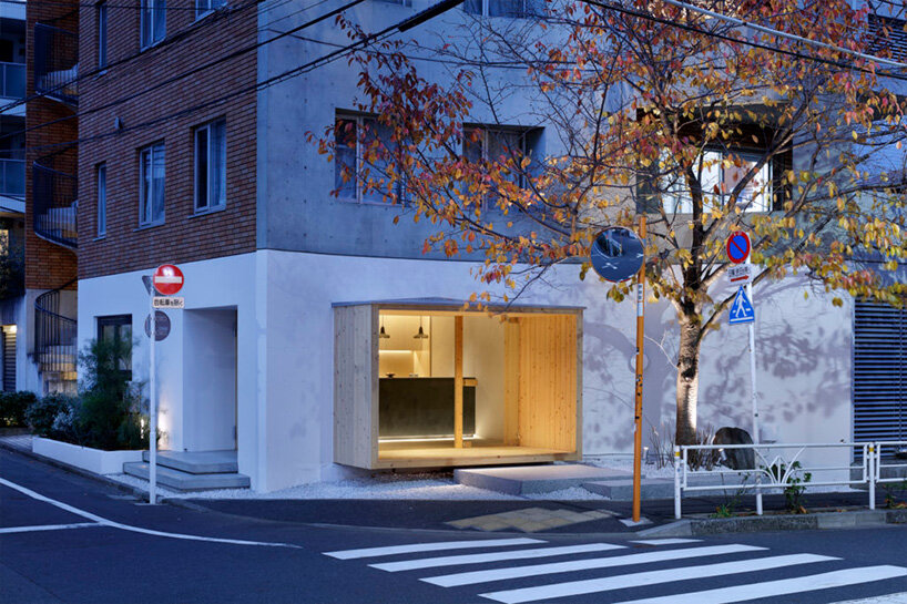 illuminated pastry shop in tokyo peeps out of extruded wooden frame 
