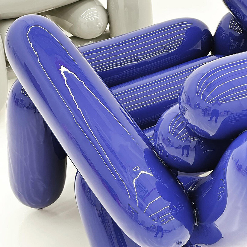 seungjin yang blows candy-colored balloons into solid chairs, stools and benches