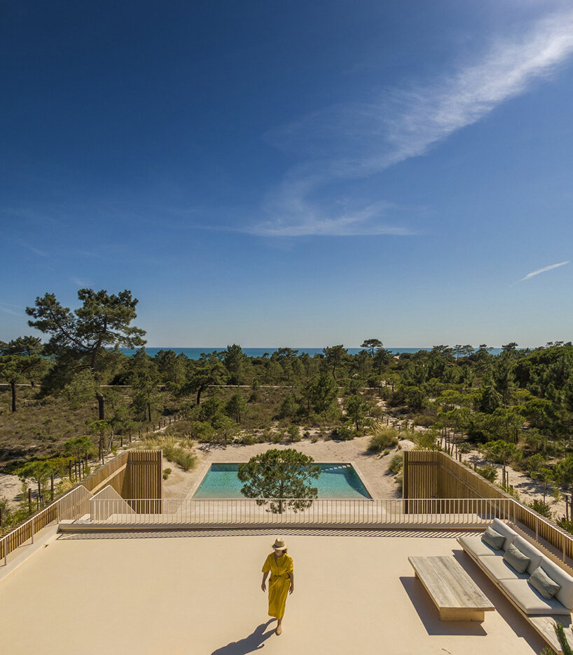 in portugal, 'casa em tróia' by BICA arquitectos seamlessly mirrors its coastal surroundings