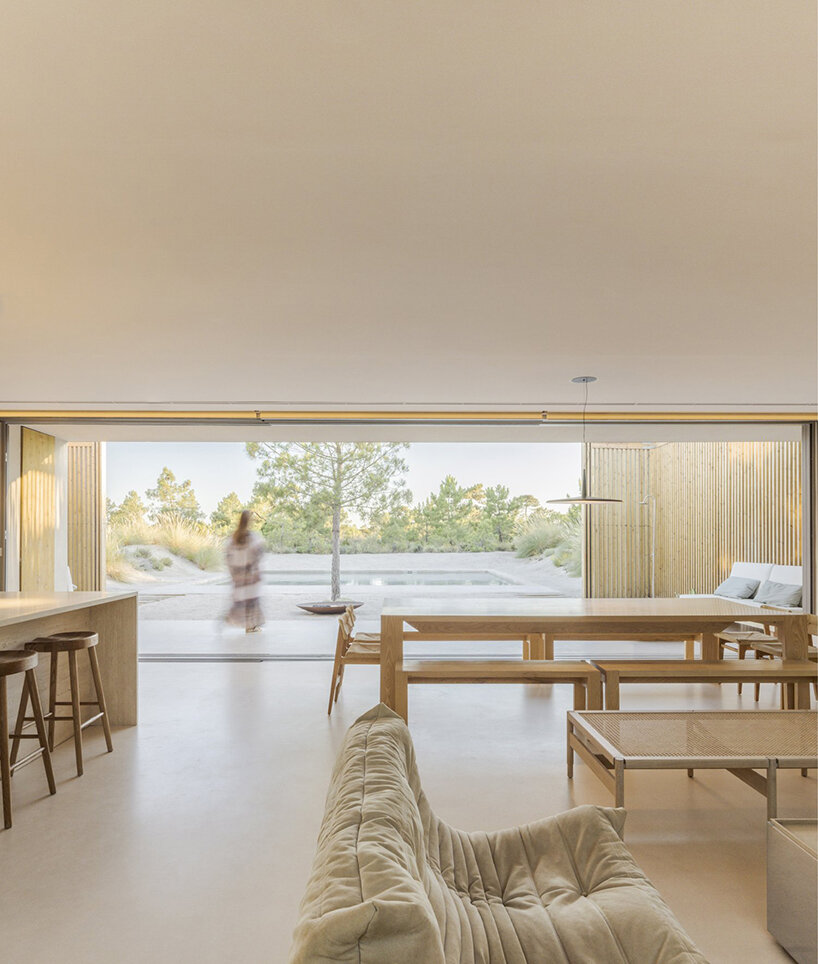 'casa em tróia' by BICA arquitectos seamlessly mirrors its coastal surroundings in portugal