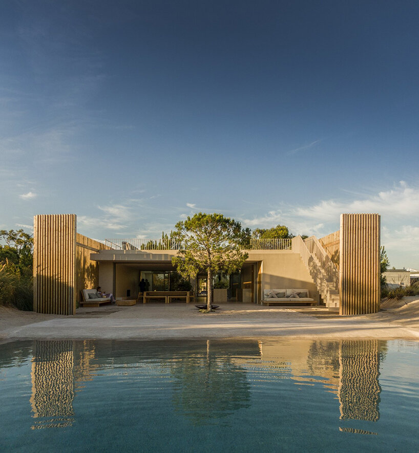 'casa em tróia' by BICA arquitectos seamlessly mirrors its coastal surroundings in portugal