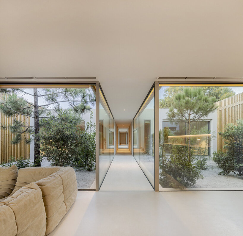 'casa em tróia' by BICA arquitectos seamlessly mirrors its coastal surroundings in portugal