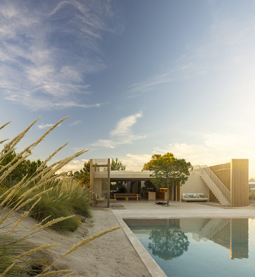 'casa em tróia' by BICA arquitectos seamlessly mirrors its coastal surroundings in portugal