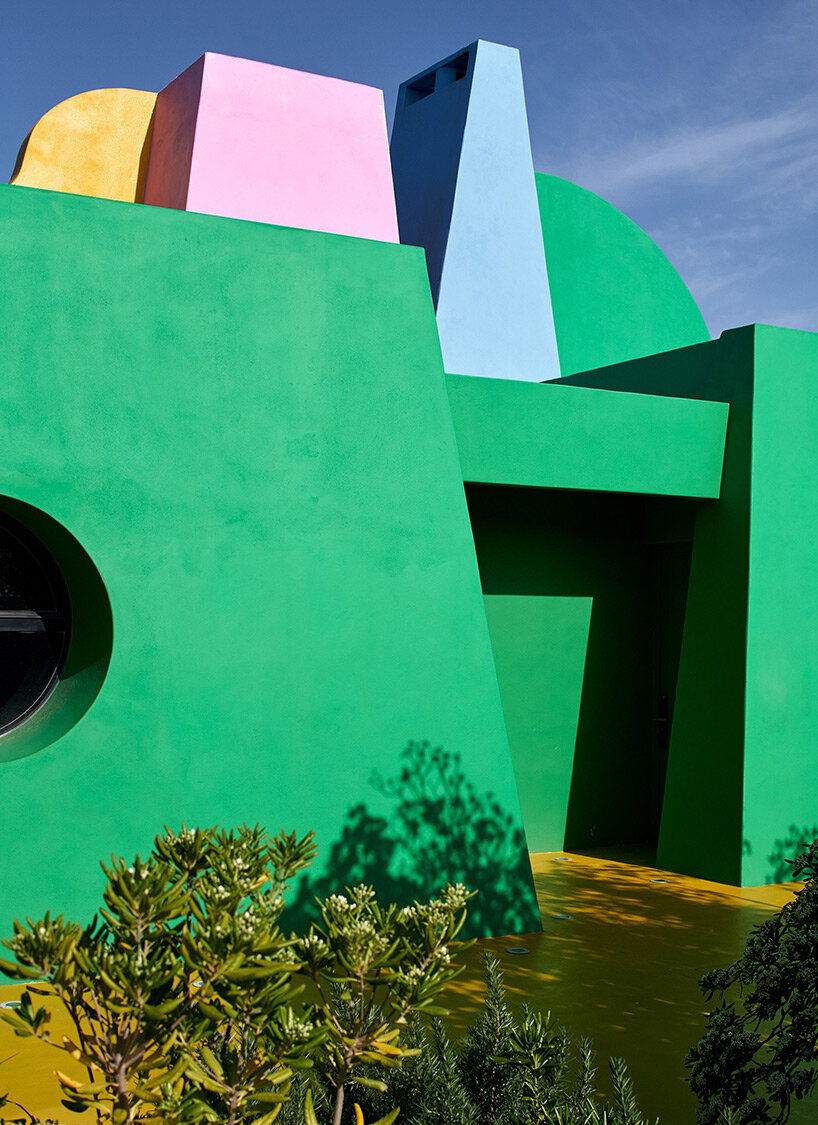 vibrant art center 'casa neptuna' stands out amid native forest landscape in uruguay