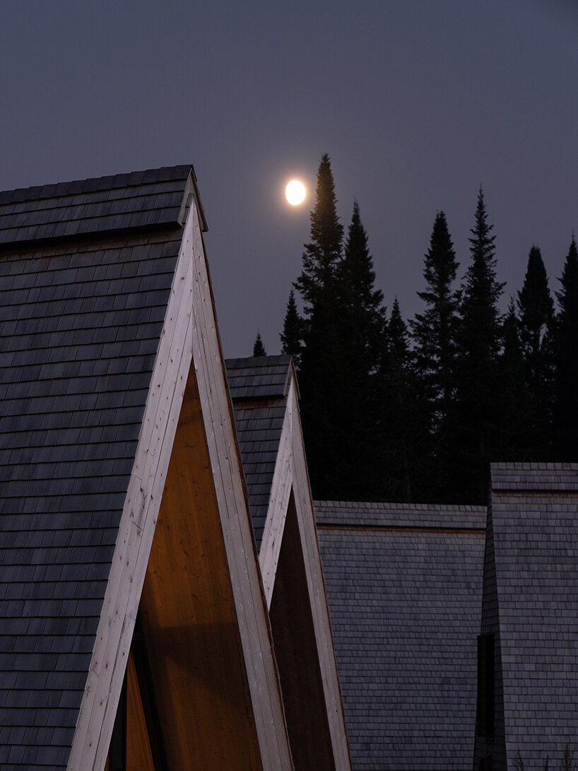 connected by a winding path, these A-frame micro cabins enliven the canadian woodland
