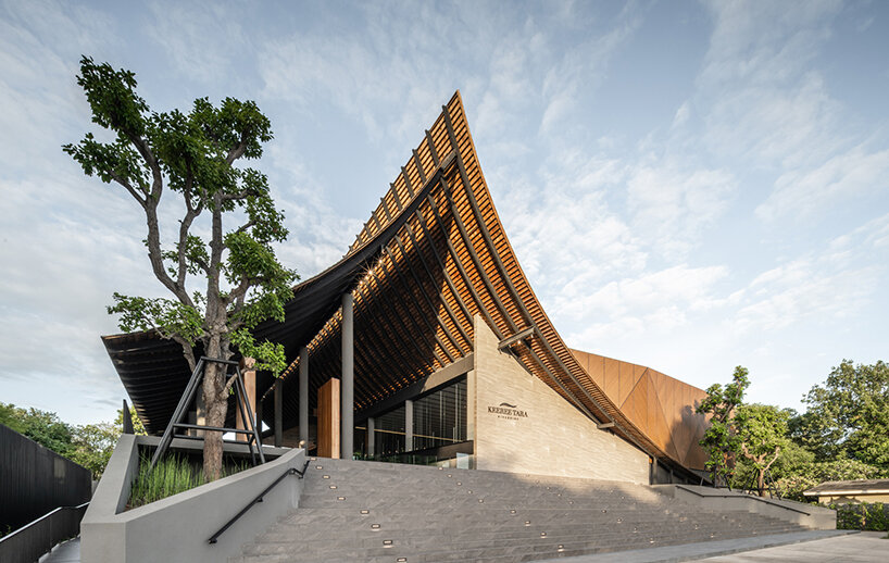 roof ridges dramatically collide atop the new keereetara restaurant in thailand