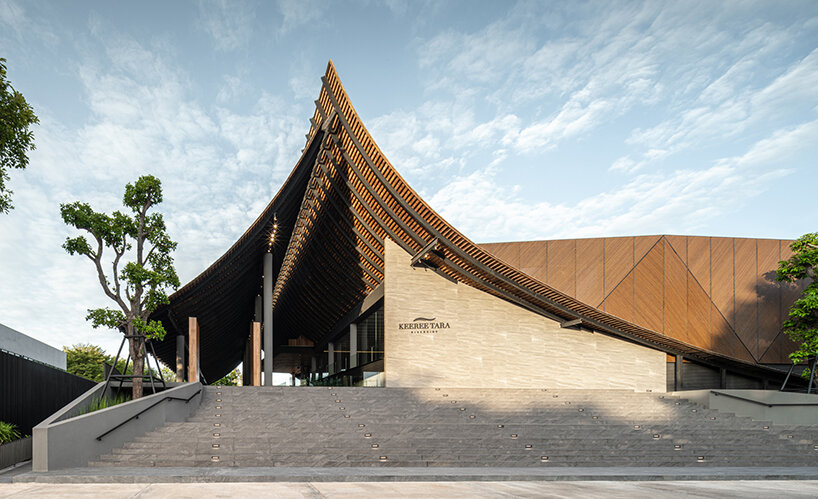 roof ridges dramatically collide atop the new keereetara restaurant in thailand