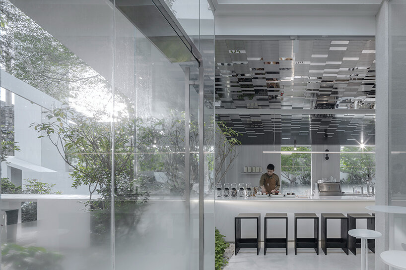bathed in a lush green ambiance, this coffee shop in bangkok doubles as a meditative retreat
