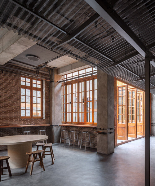 blue bottle coffee shop by neri&hu is a 'primitive shed' within historic shanghai house