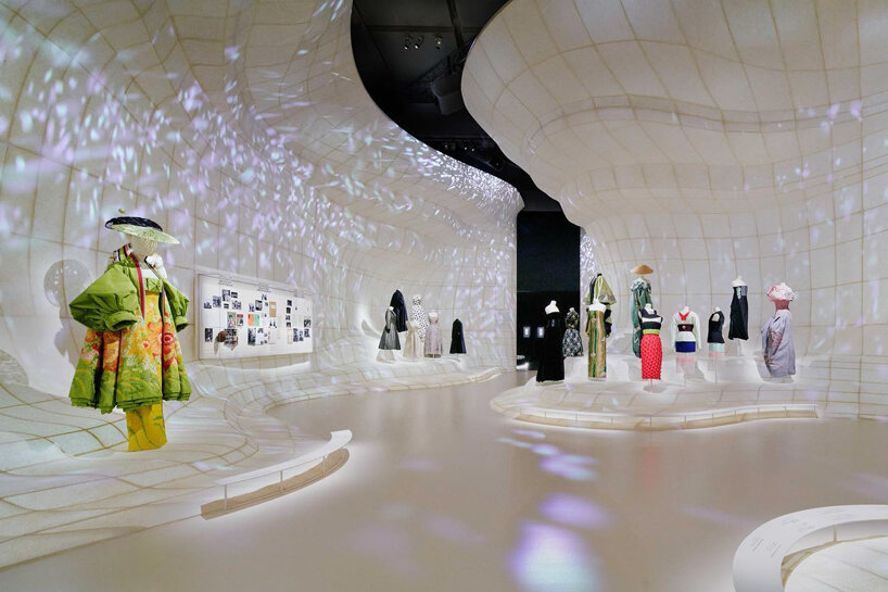 mannequins in gowns climb up a giant slope in OMA-designed dior 