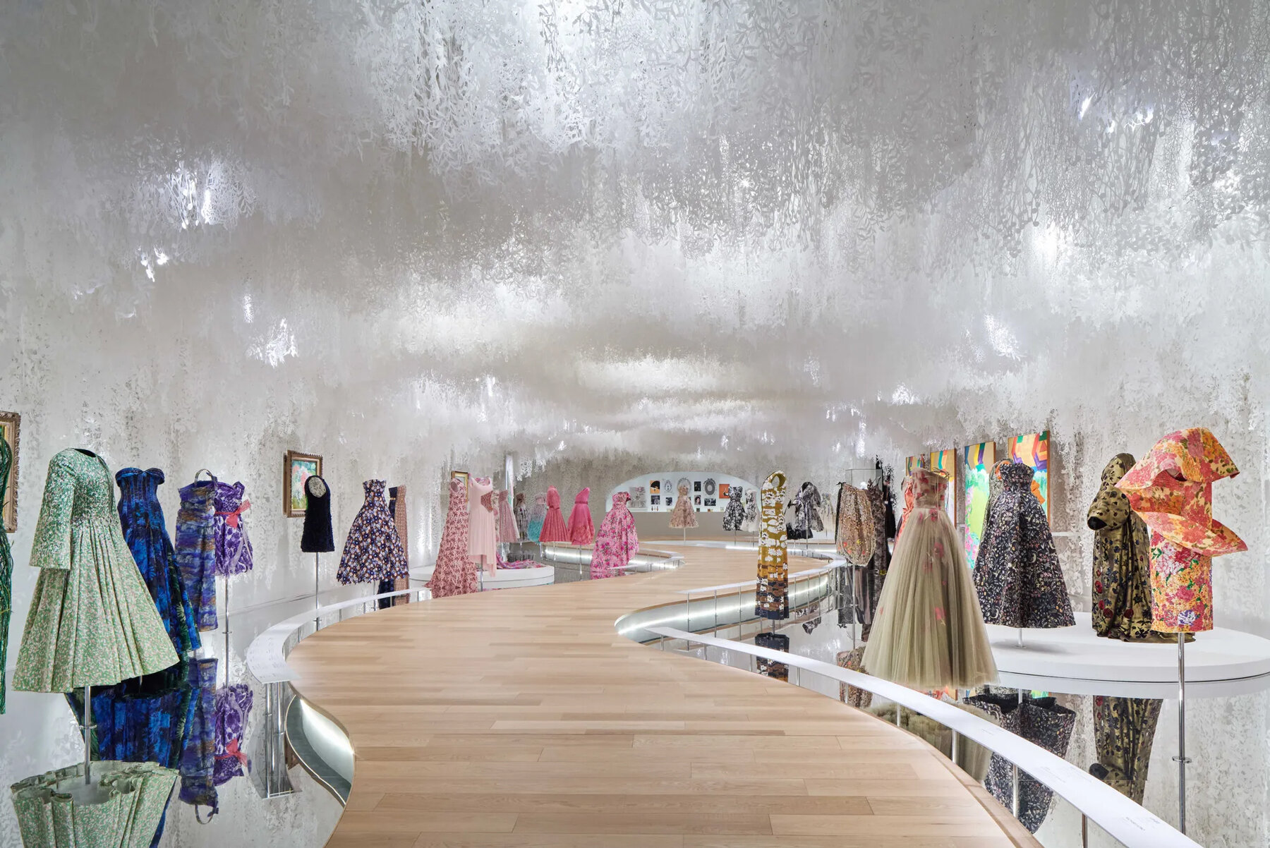 mannequins in gowns climb up a giant slope in OMA-designed dior 
