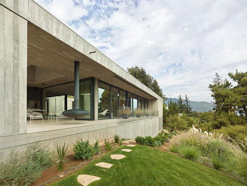 centered around a patio, this house in chile subtly meshes exposed concrete with travertine
