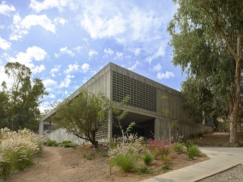 centered around a patio, this house in chile subtly meshes exposed concrete with travertine