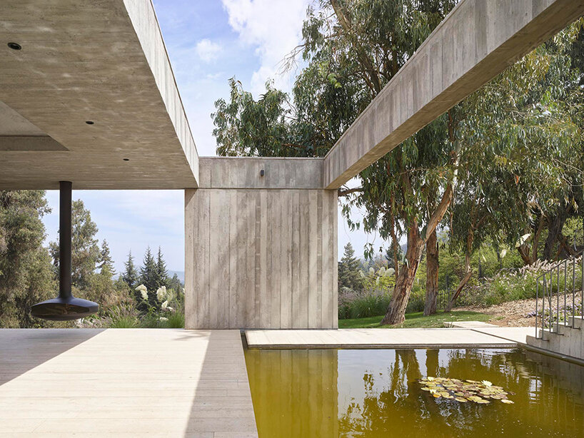 centered around a patio, this house in chile subtly meshes exposed concrete with travertine