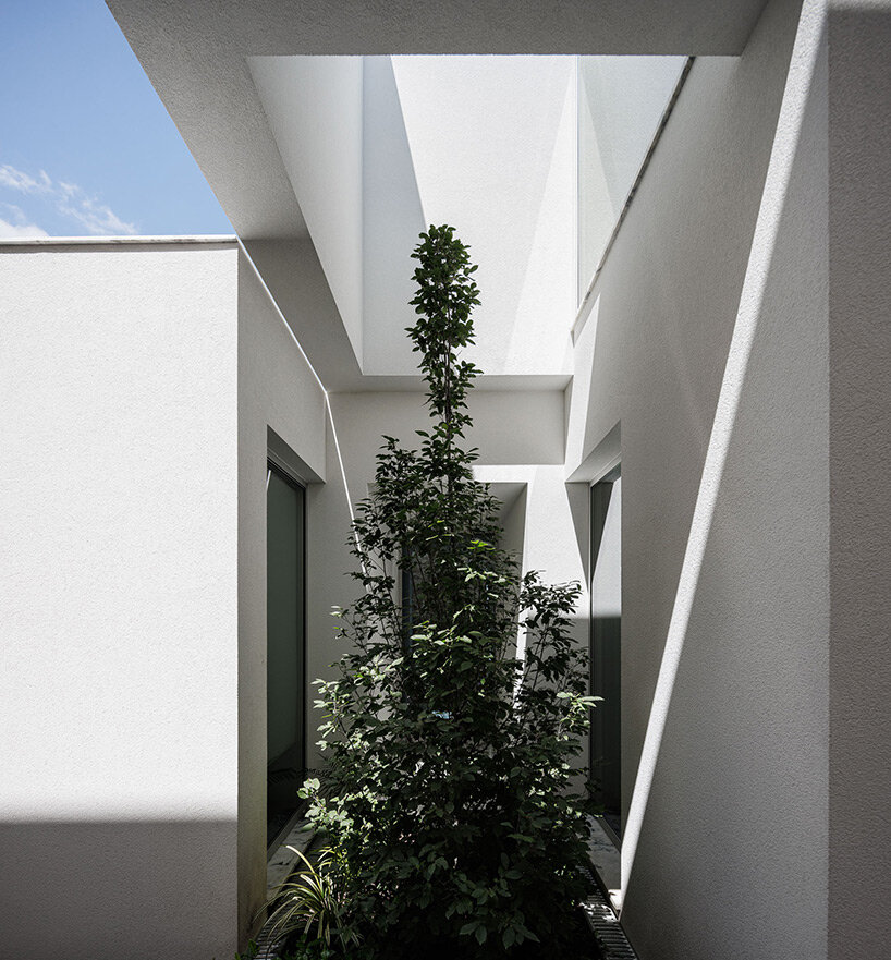 pema studio shelters home behind original façade in dense urban portugal