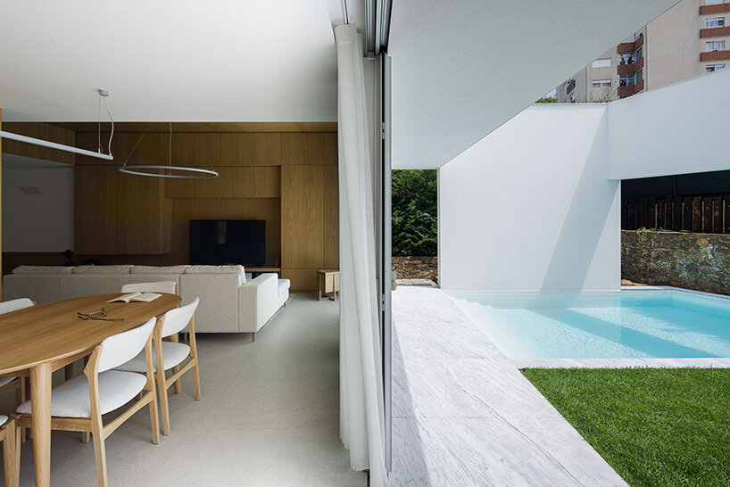 pema studio shelters home behind original façade in dense urban portugal