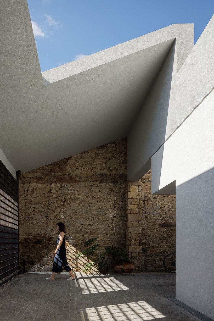 pema studio shelters home behind original façade in dense urban portugal