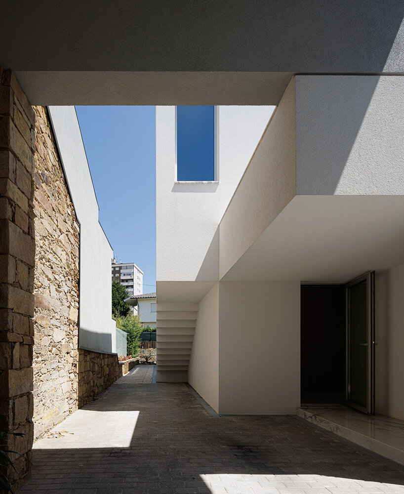 pema studio shelters home behind original façade in dense urban portugal