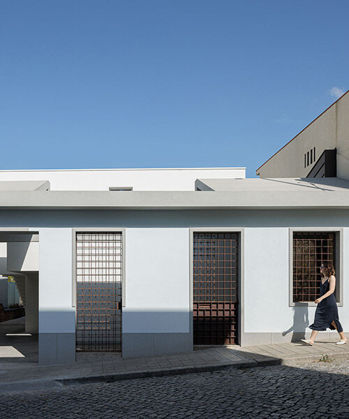 pema studio shelters home behind original façade in dense urban portugal