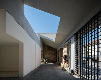 pema studio shelters home behind original façade in dense urban portugal
