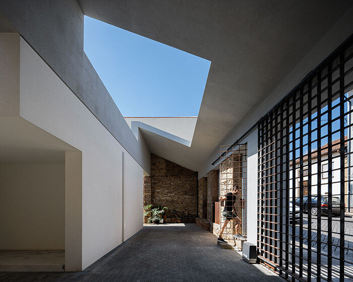 pema studio shelters home behind original façade in dense urban portugal