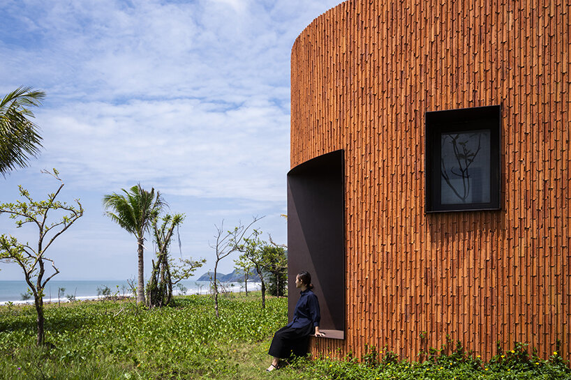 a vivid brick shell envelops inrestudio's bean-shaped laboratory in vietnam
