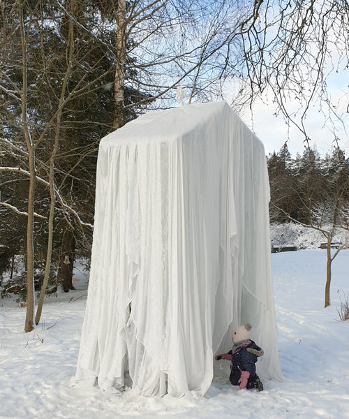 frozen curtains hover above a blanket of snow to form UMA's whimsical icy pavilion