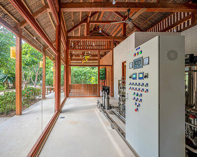 chi.arch nestles zero-waste water bottling plant in forest resort in vietnam