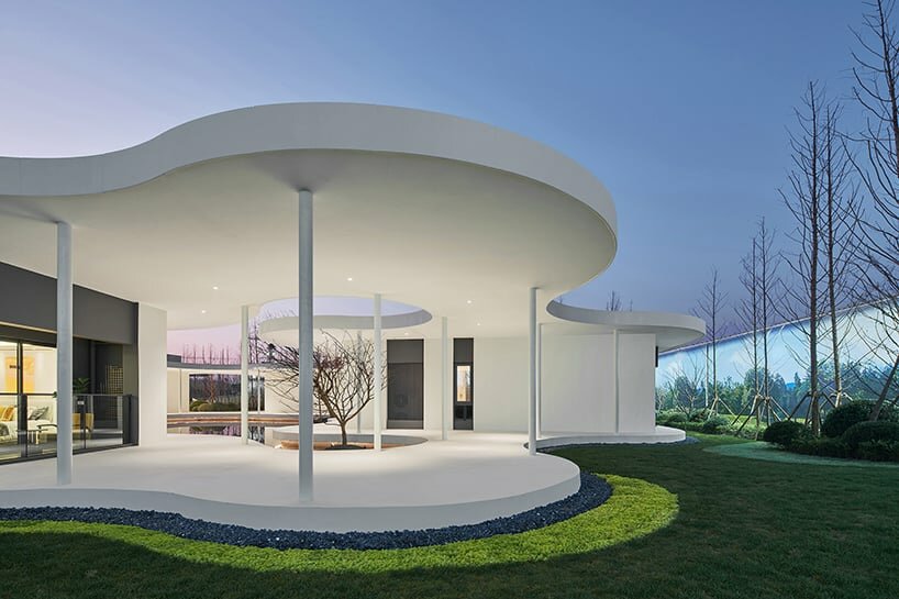 white orchid pavilion in china unravels exhibition booth in curved abstract forms