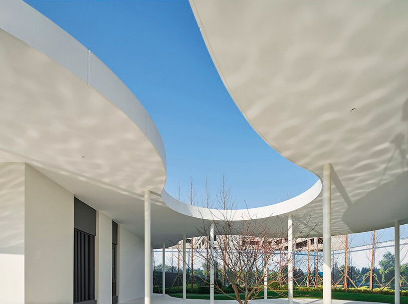 white orchid pavilion in china unravels exhibition booth in curved abstract forms