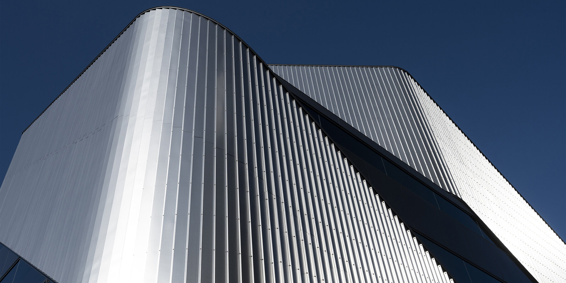 stainless steel curtains gently wrap around japan's 010 BUILDING