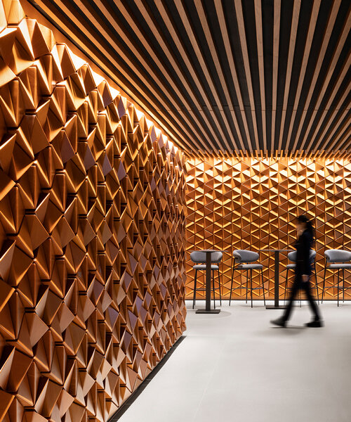 andrea maffei architects clads milan's DAV restaurant interior in pyramid wooden panelling