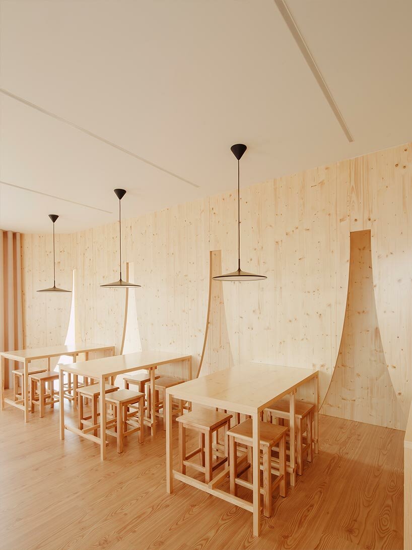 funnel-shaped cutouts finish snug restaurant in portugal