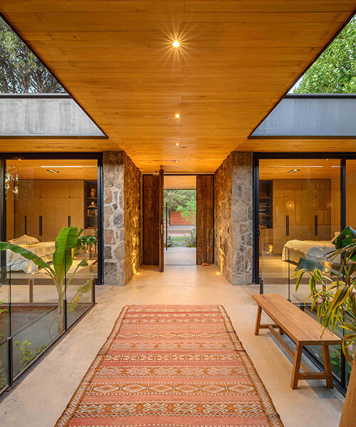 a house of stone dubbed 'casa piedra' shows warm interiors in argentina