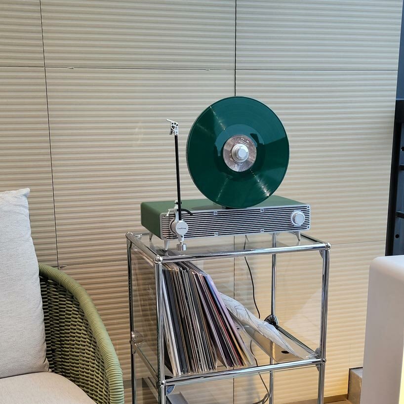 sleek vertical turntable brings bold colors & vintage mood to any room