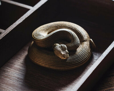 coppertist.wu hand engraves over 14,000 scales on this elegant viper bottle opener