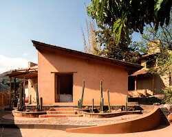 adobe skin made of clay and straw shapes vacation house 'casa corsal' in mexico