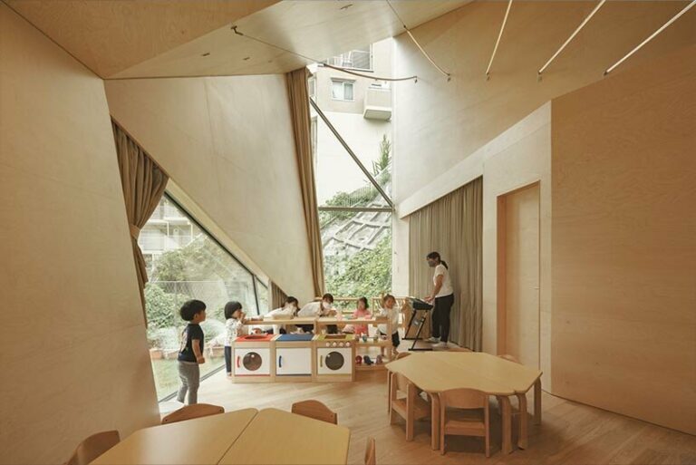 uneven geometry rises dramatically for kengo kuma's daycare center in japan