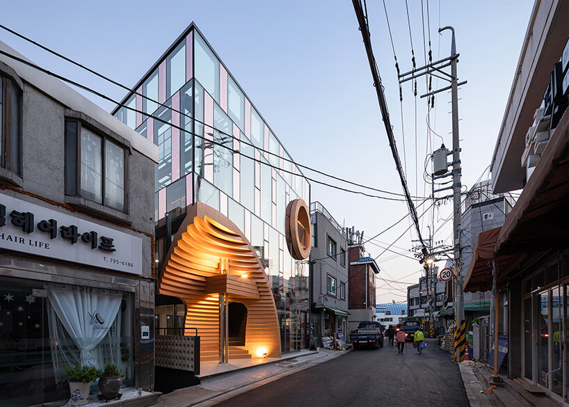 concrete cuts + curves adorn the 'diagon' building by moon hoon