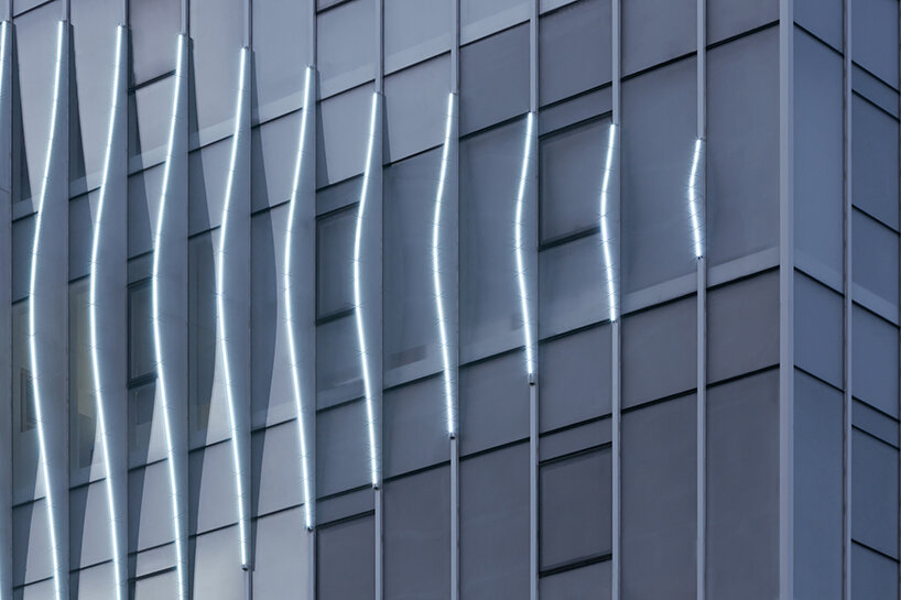 feather-shaped reliefs adorn this mixed-use building façade in eastern china
