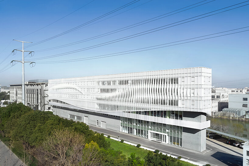 feather-shaped reliefs adorn this mixed-use building façade in eastern china