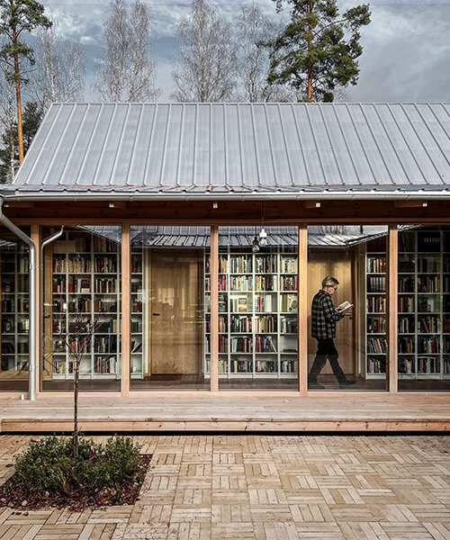 emerging from a swedish forest, fria folket's house is organized around an extensive library