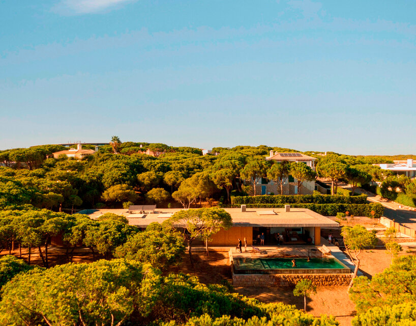 sliding wooden slats transform summer residence's outline in portugal