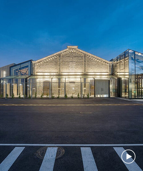 historic latvian cargo warehouse revived as cultural center, encased in glass and steel shell