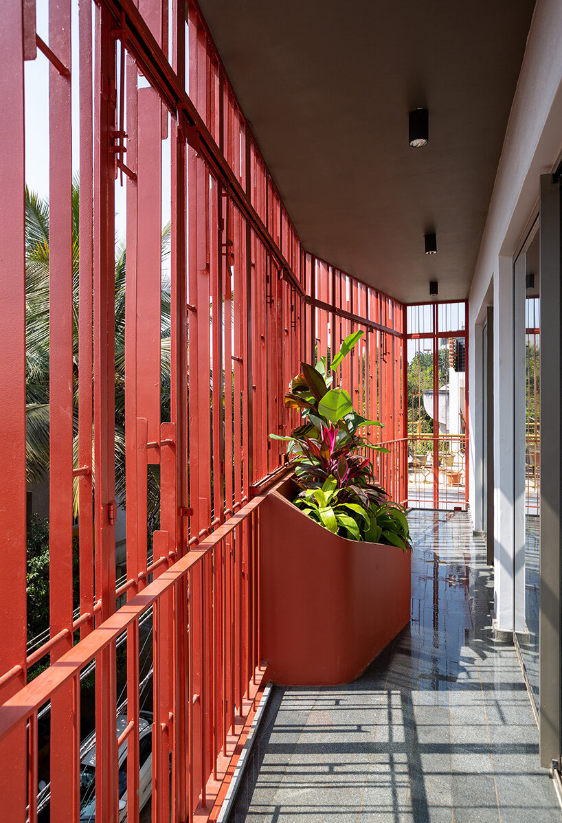 deep red-terracotta screens bring dynamic porosity to 'house on 46' in bangalore